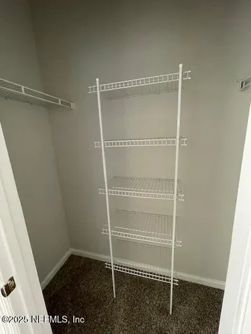 an empty room with wooden floor and mirror