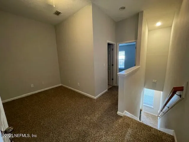 an empty room with windows and closet