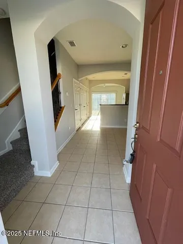 a view of a hallway to rooms