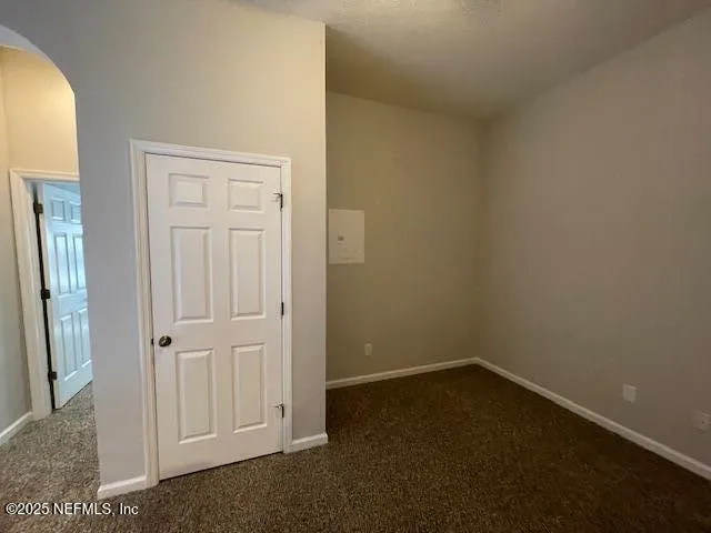 a front view of a house with a garden and parking space