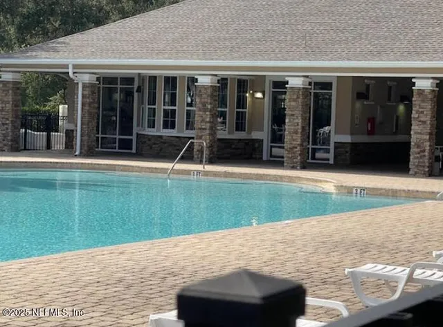 a view of outdoor space with swimming pool and seating