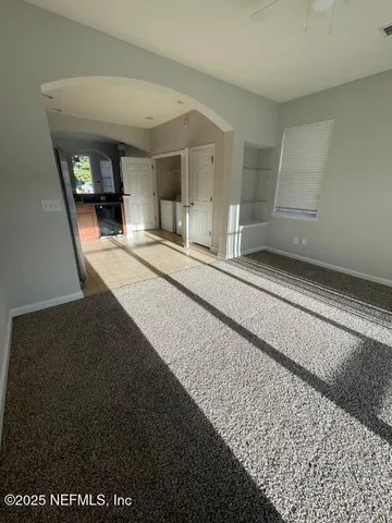 a kitchen with a sink a stove cabinets and a window