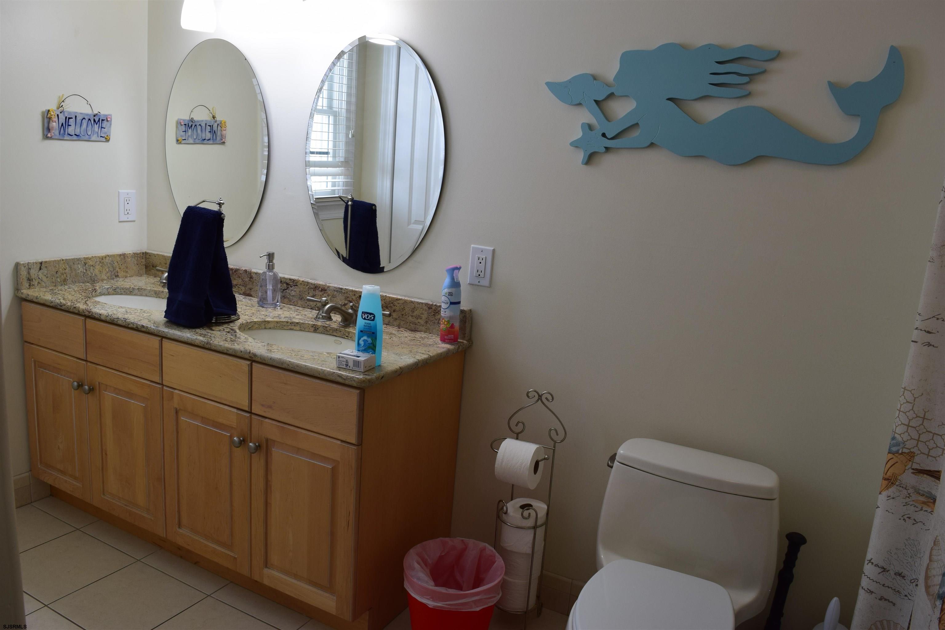 205 West Brigantine Avenue Brigantine, NJ 08203 - Photo 15 of 31 a bathroom with a toilet sink and mirror
