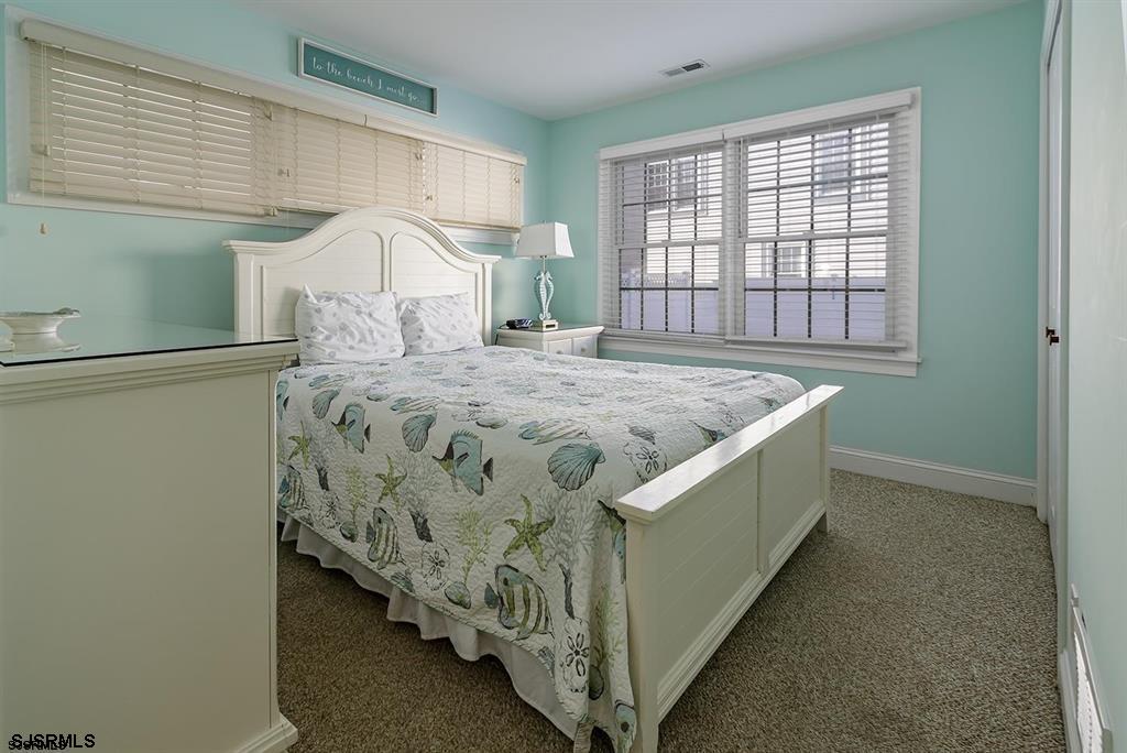 205 West Brigantine Avenue Brigantine, NJ 08203 - Photo 16 of 31 a bed sitting in a bedroom next to a window