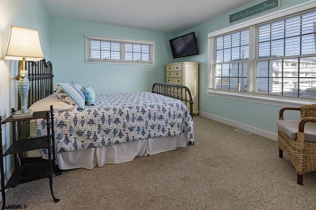 205 West Brigantine Avenue Brigantine, NJ 08203 - Photo 17 of 31 a bed sitting in a bedroom next to a window