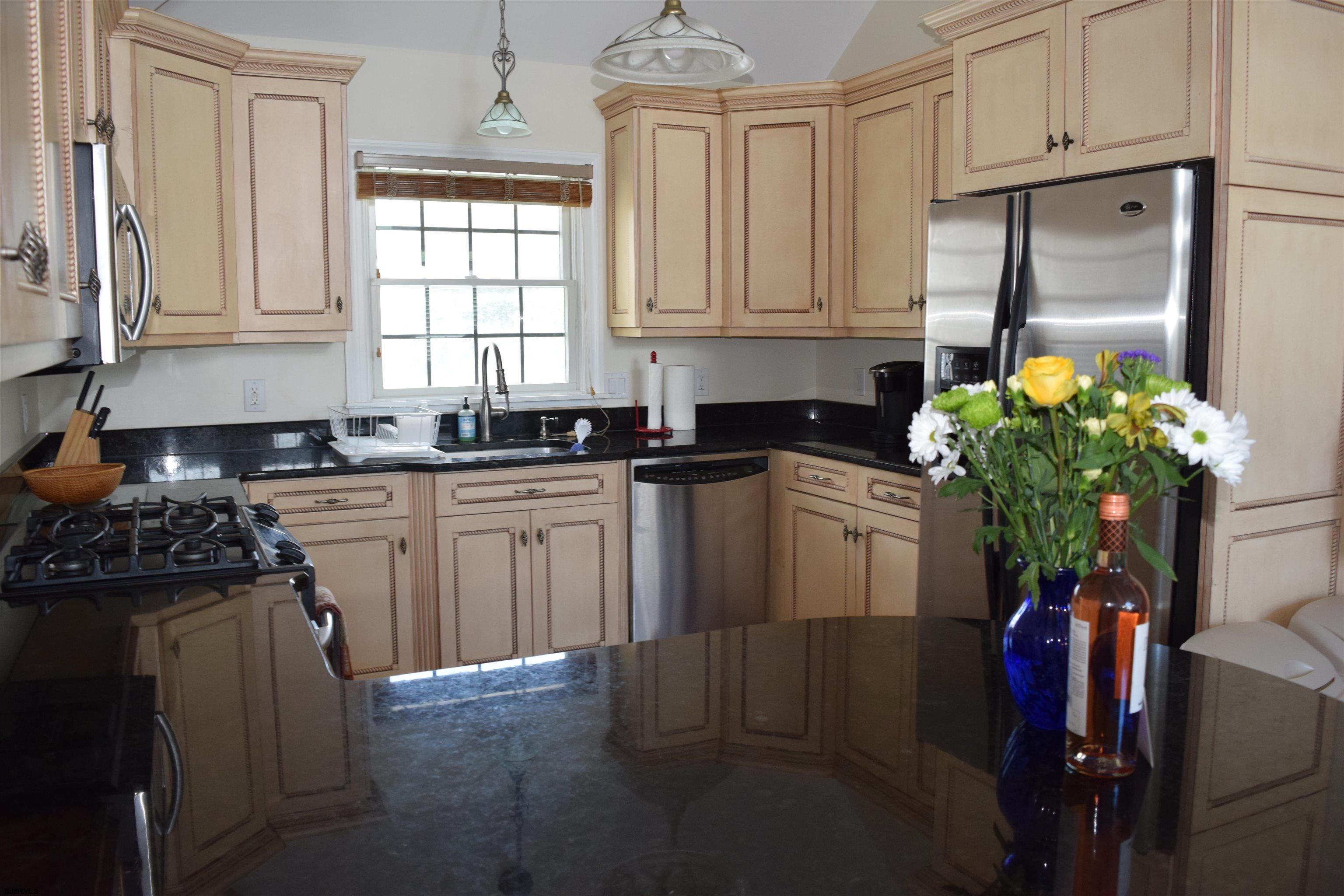 205 West Brigantine Avenue Brigantine, NJ 08203 - Photo 2 of 31 a kitchen with stainless steel appliances granite countertop a refrigerator sink and cabinets