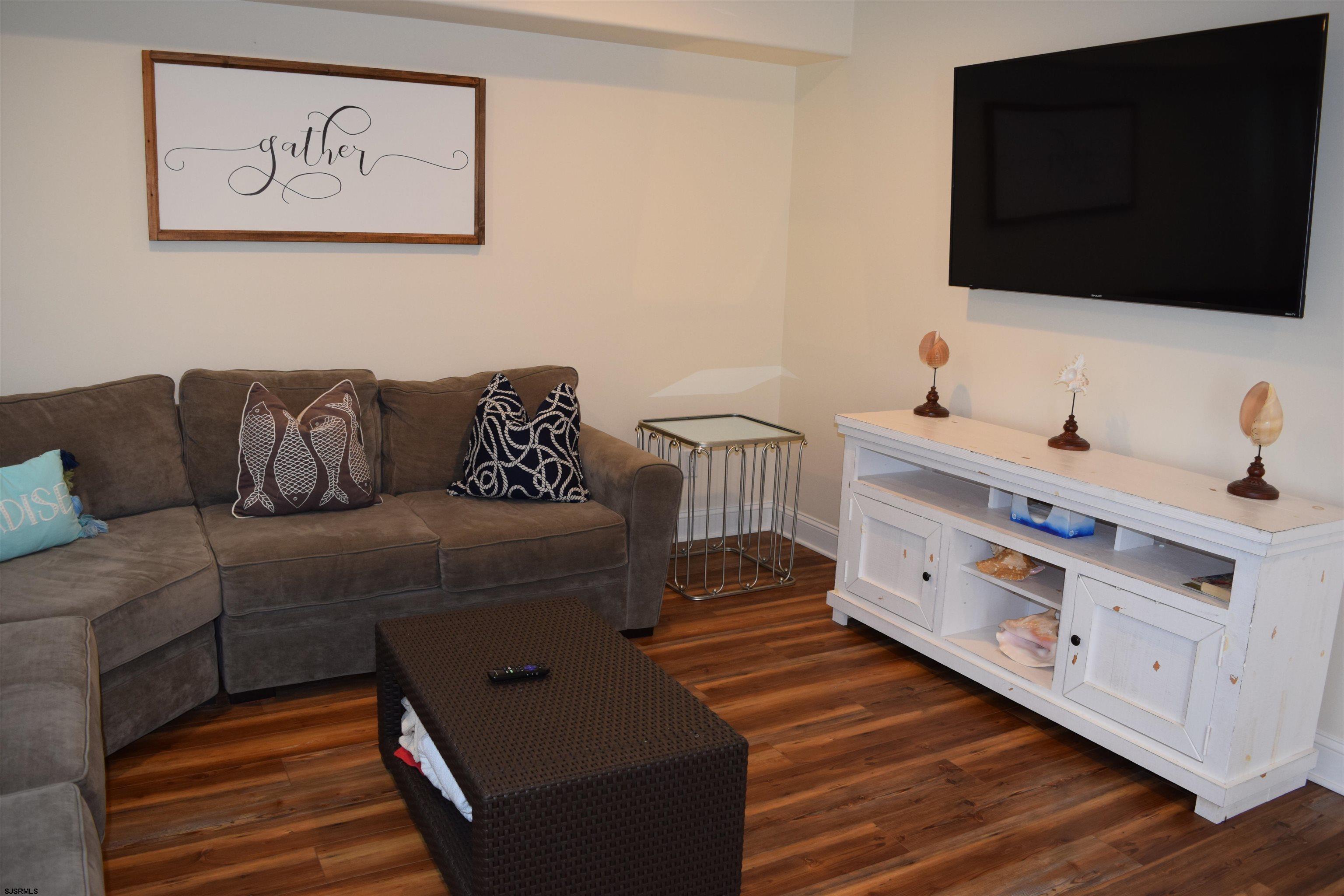 205 West Brigantine Avenue Brigantine, NJ 08203 - Photo 21 of 31 a living room with furniture and a flat screen tv