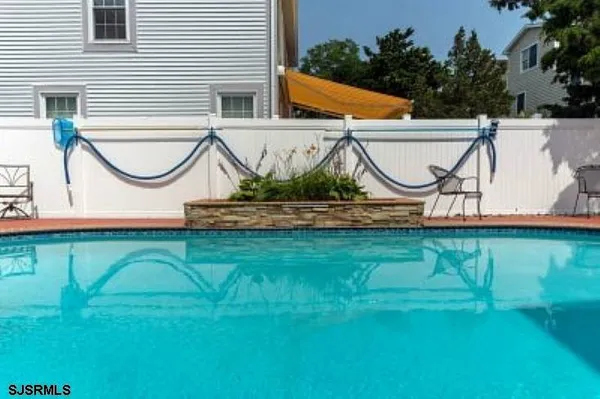 a backyard of a house with wooden floor and a bench