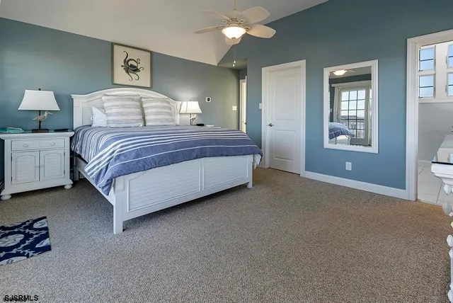 a bedroom with a bed wall painting and window
