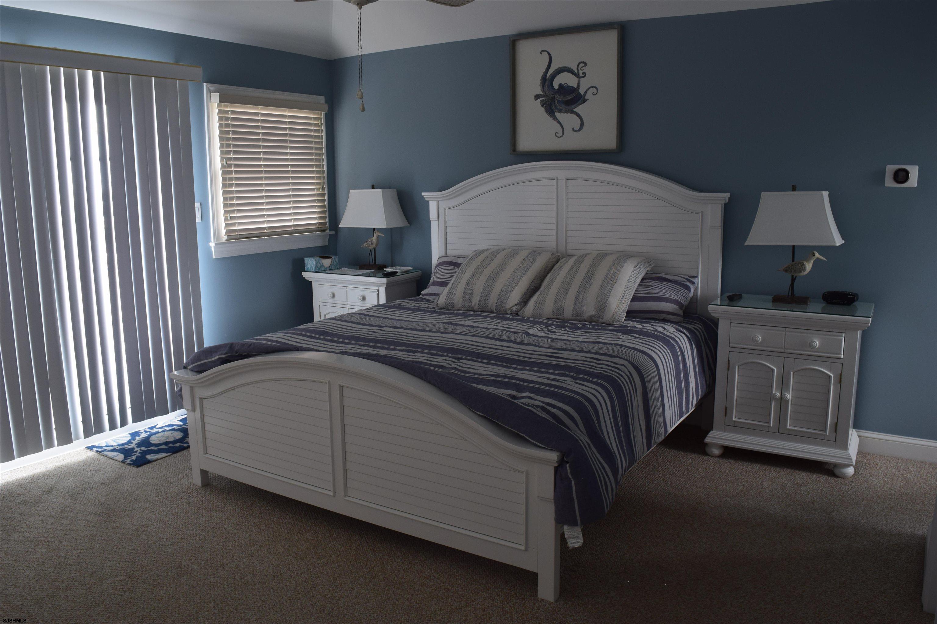 205 West Brigantine Avenue Brigantine, NJ 08203 - Photo 8 of 31 a bed sitting in a bedroom next to a window