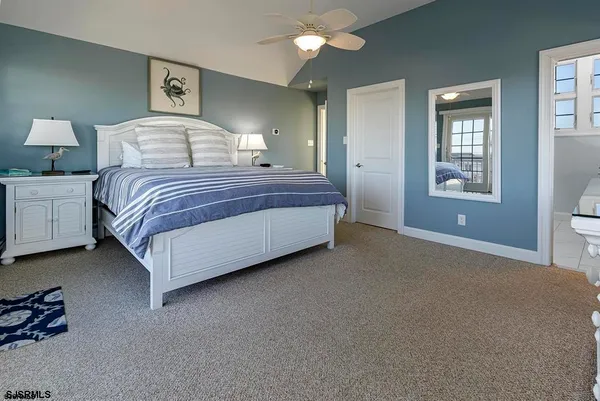 a bedroom with a bed wall painting and window