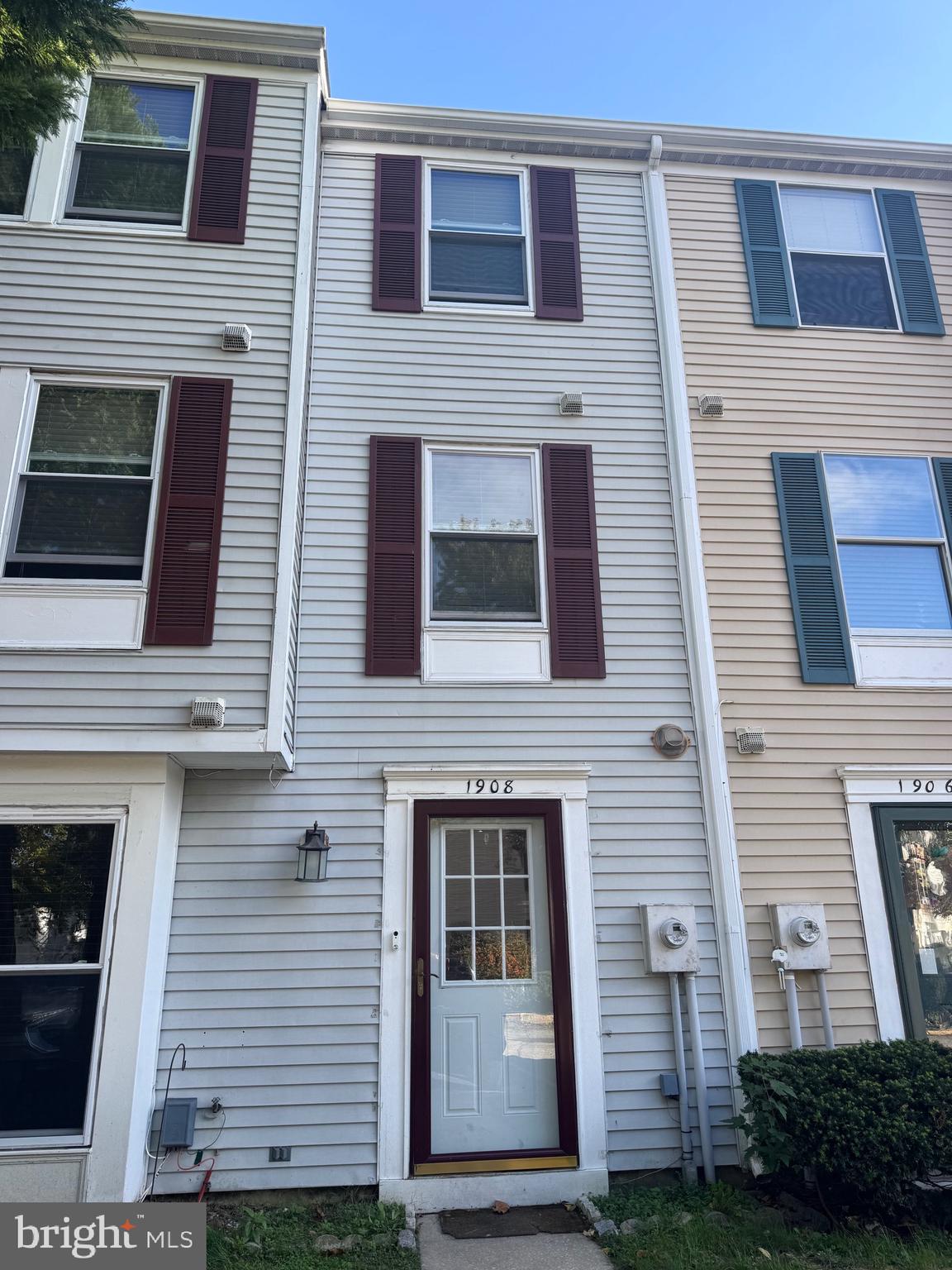 a view of a brick house with many windows
