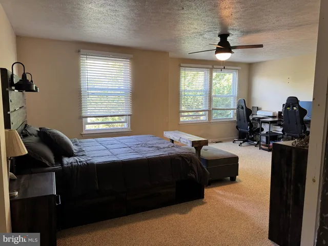 a bedroom with bed and window