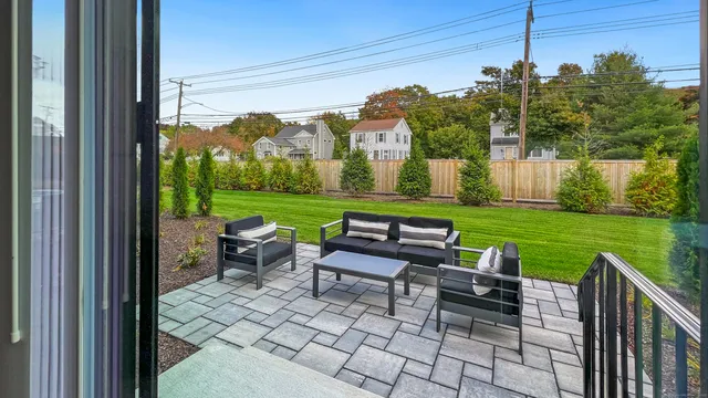 a view of a chairs and table in patio with a yard