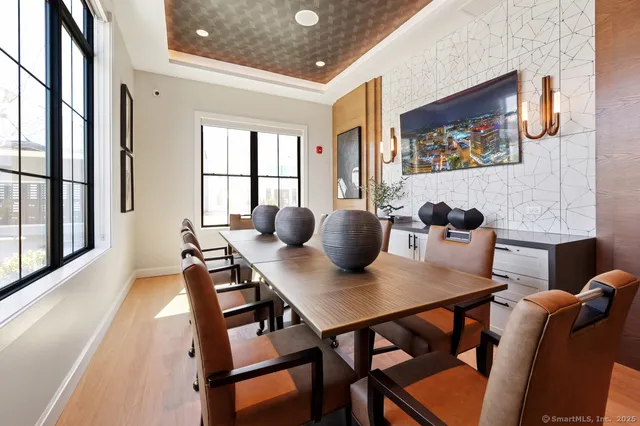 a view of a dining room with furniture and a potted plant