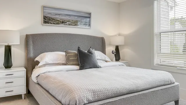 a bedroom with a bed and a night stand