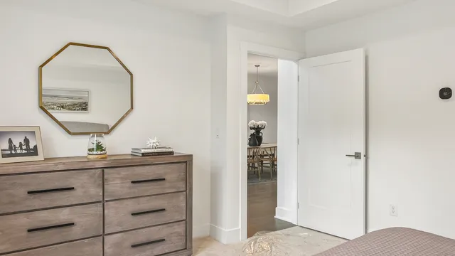 a view of room with mirror and a wooden floor