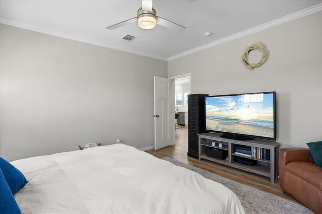 a bedroom with bed and flat screen tv