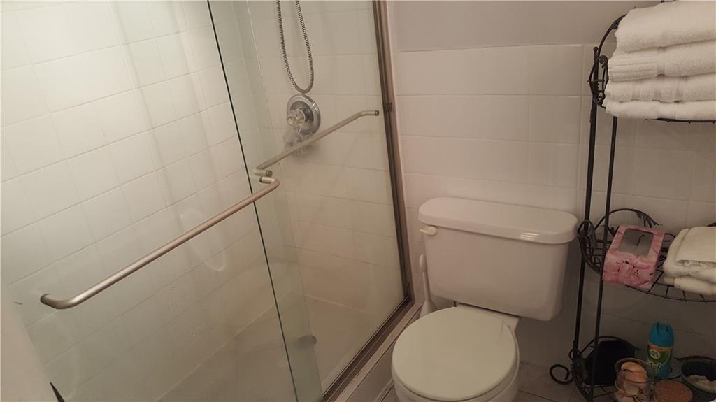 1110 North Riverside Drive, Unit 29 Pompano Beach, FL 33062 - Photo 8 of 17 a white toilet sitting next to a shower