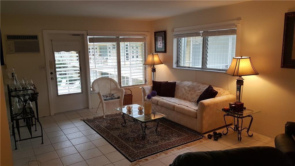 1110 North Riverside Drive, Unit 29 Pompano Beach, FL 33062 - Photo 9 of 17 a living room with furniture and a window