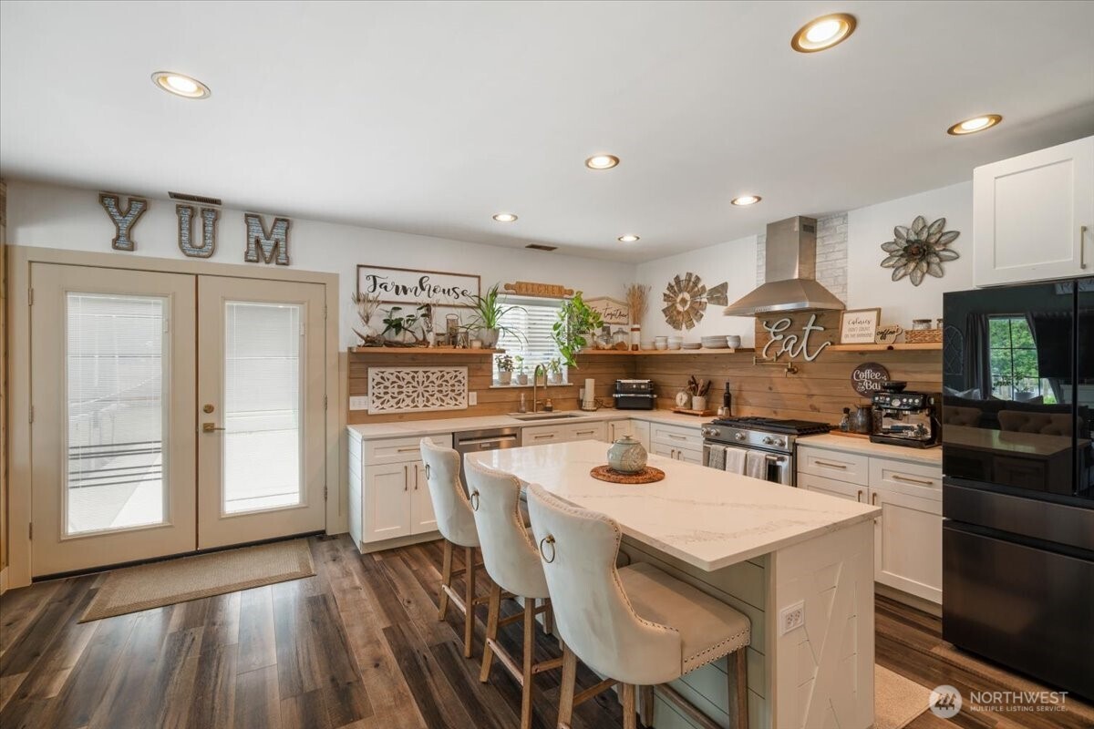26709 Entwhistle Road East Buckley, WA 98321 - Photo 10 of 40 a kitchen with a table chairs refrigerator and cabinets
