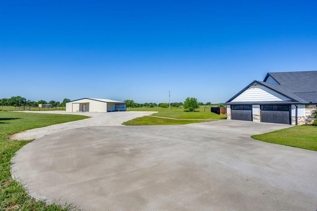 733 Fm 2652 Graham, TX 76450 - Photo 32 of 40 a front view of a house with a yard and garage