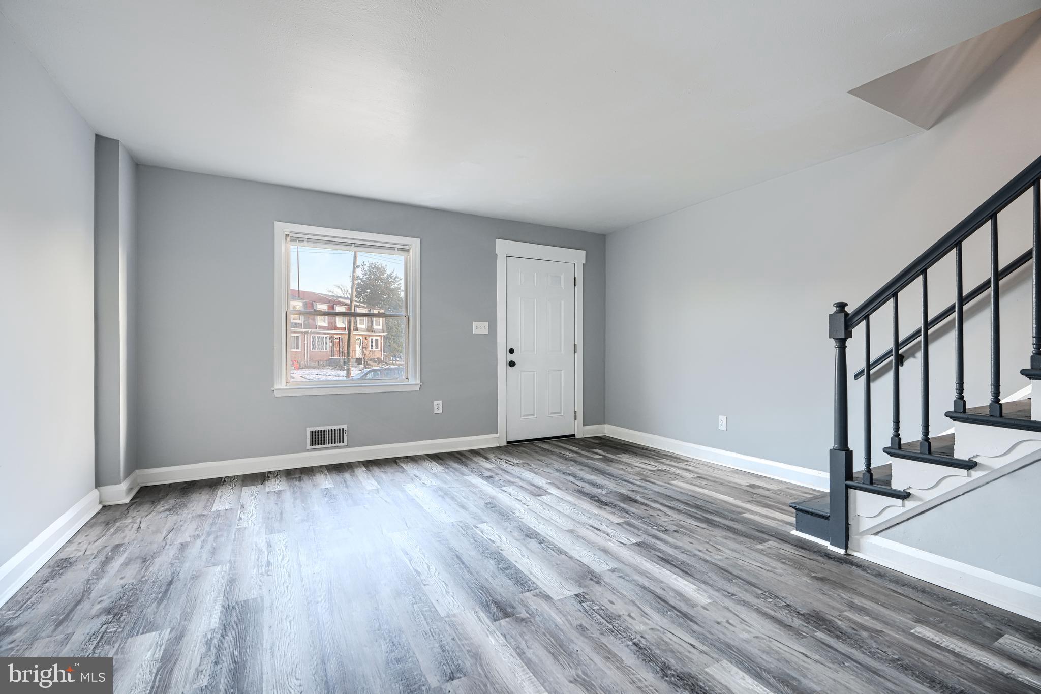 2123 Graythorn Road Middle River, MD 21220 - Photo 4 of 29 a view of an empty room with wooden floor and a window