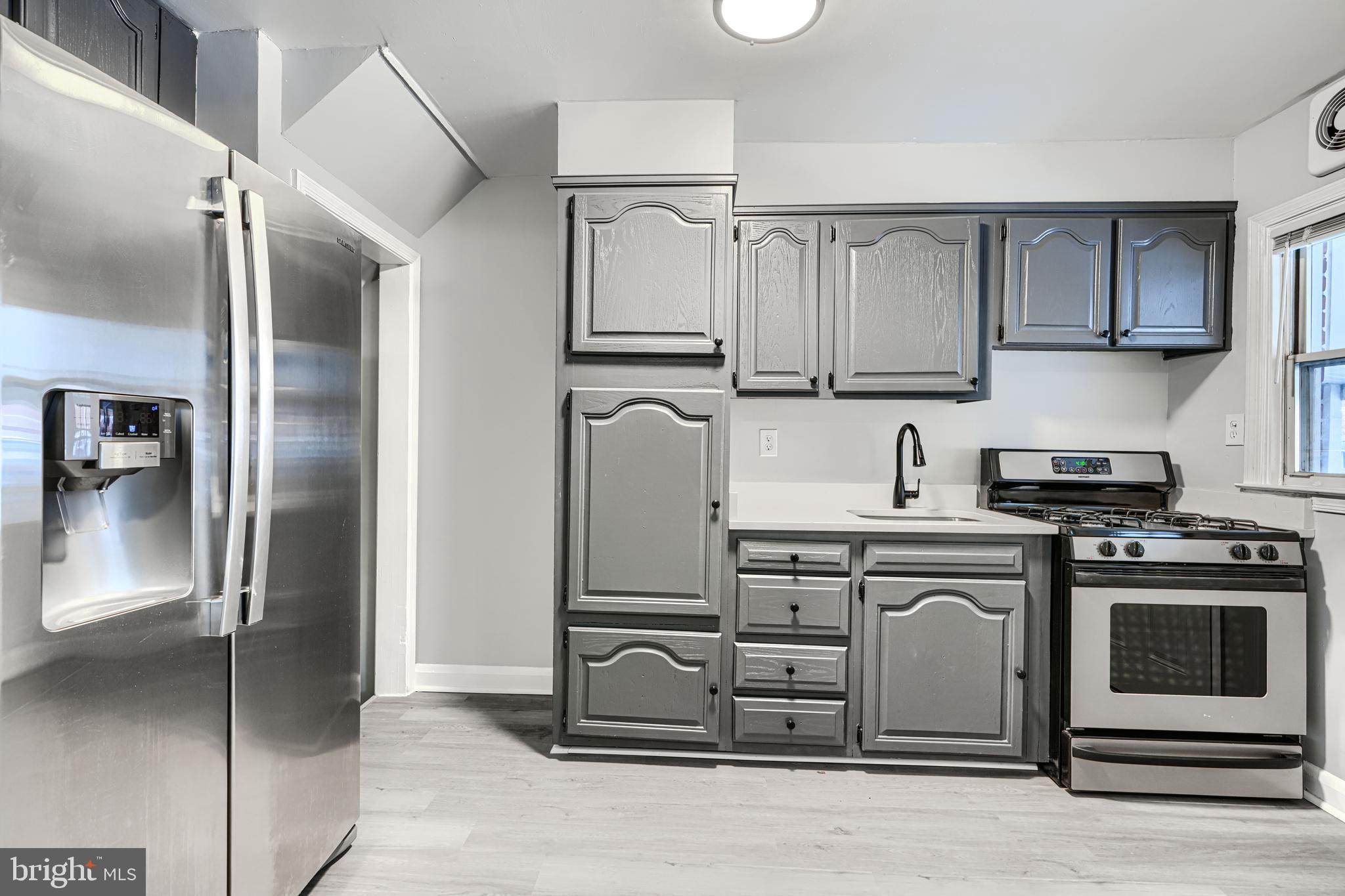 2123 Graythorn Road Middle River, MD 21220 - Photo 6 of 29 a kitchen with stainless steel appliances granite countertop a refrigerator a stove and a sink