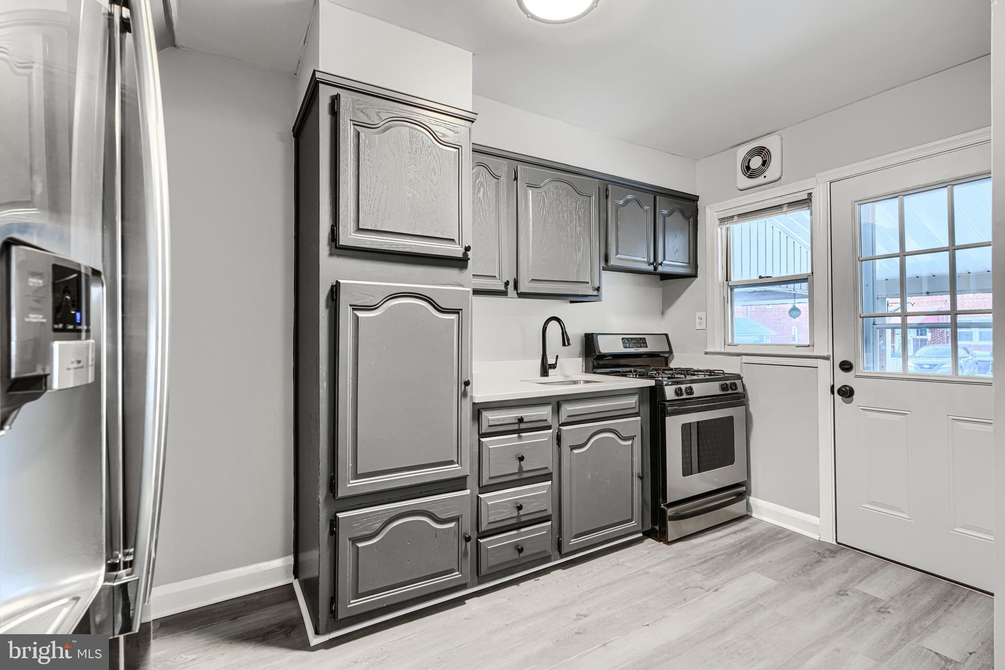 2123 Graythorn Road Middle River, MD 21220 - Photo 7 of 29 a kitchen with stainless steel appliances granite countertop a refrigerator sink and stove