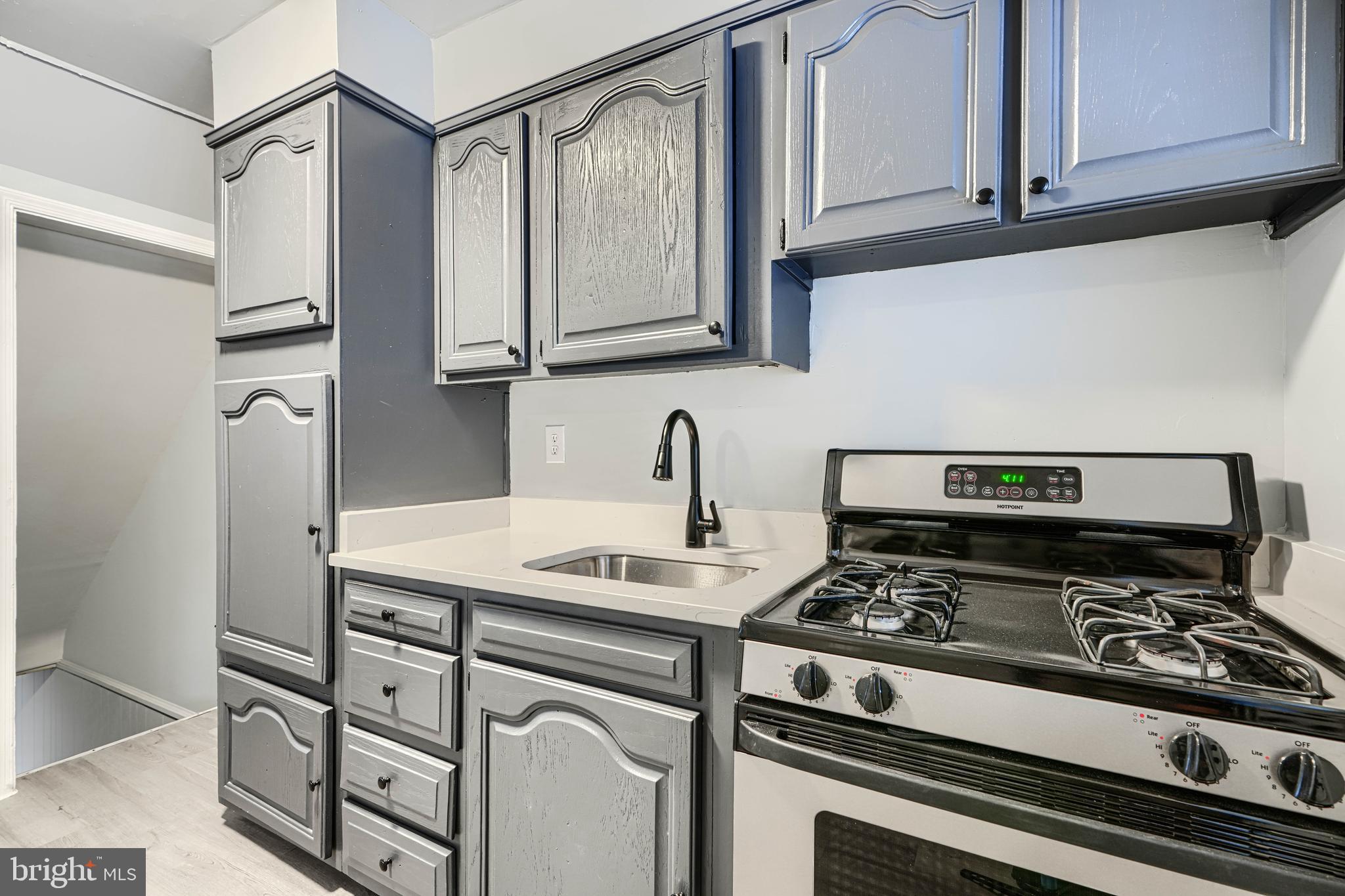 2123 Graythorn Road Middle River, MD 21220 - Photo 9 of 29 a kitchen with stainless steel appliances granite countertop a sink stove and cabinets