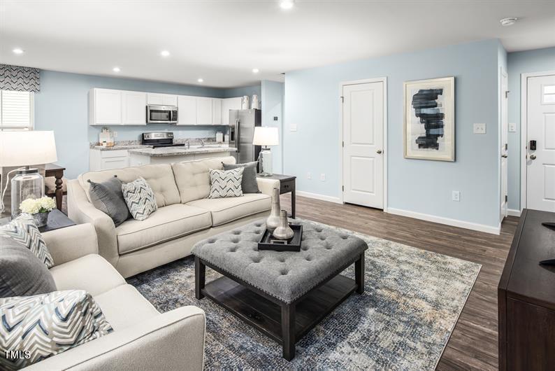 237 Suburban Meadow Pass Wendell, NC 27591 - Photo 4 of 15 a living room with furniture and kitchen view
