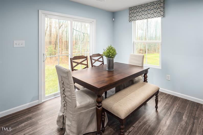 237 Suburban Meadow Pass Wendell, NC 27591 - Photo 8 of 15 a view of a dining room with furniture and wooden floor