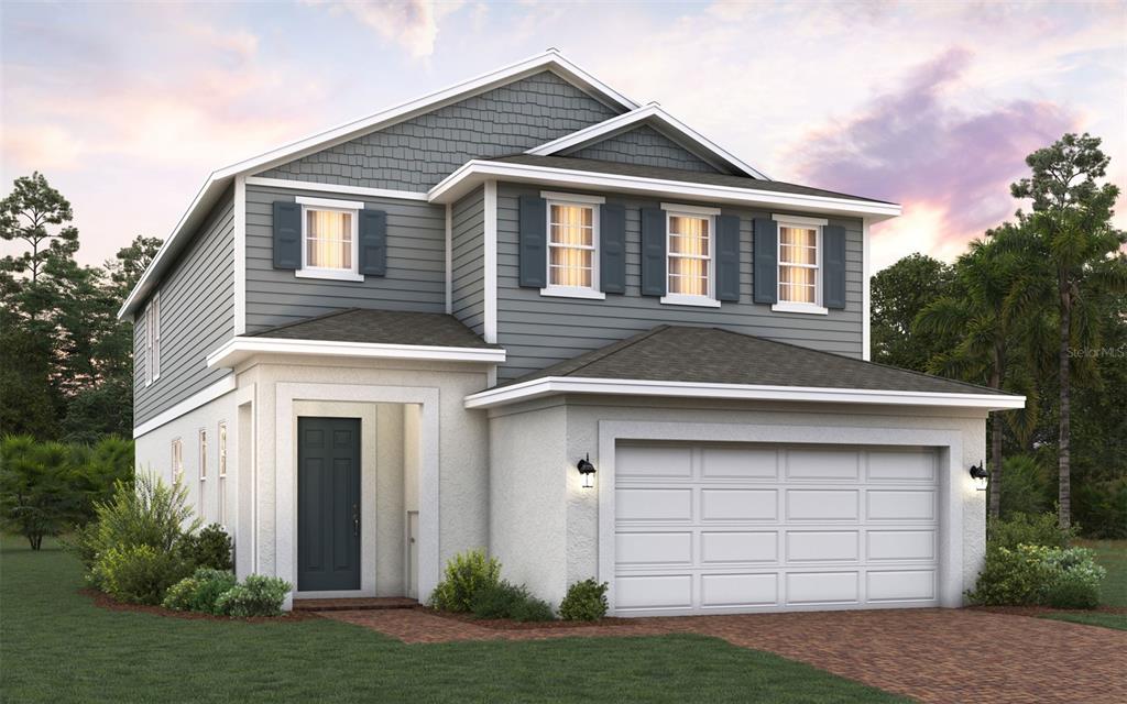 a front view of a house with a garden and garage