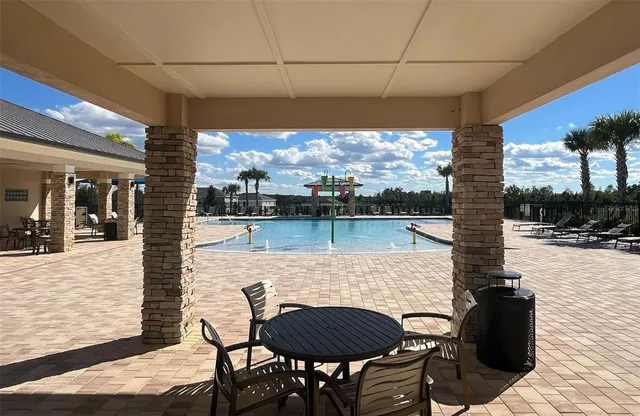 a view of swimming pool with outdoor seating and yard