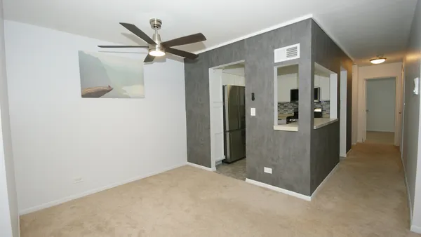 an empty room with windows and closet
