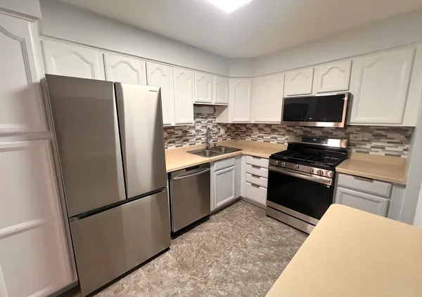 a kitchen with a refrigerator stove and microwave