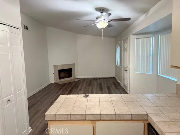 a view of an empty room with a fireplace and a window