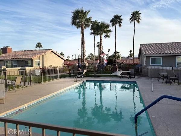 a view of a swimming pool with chairs