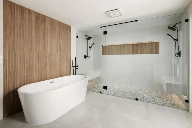 a bathroom with a granite countertop toilet and a sink