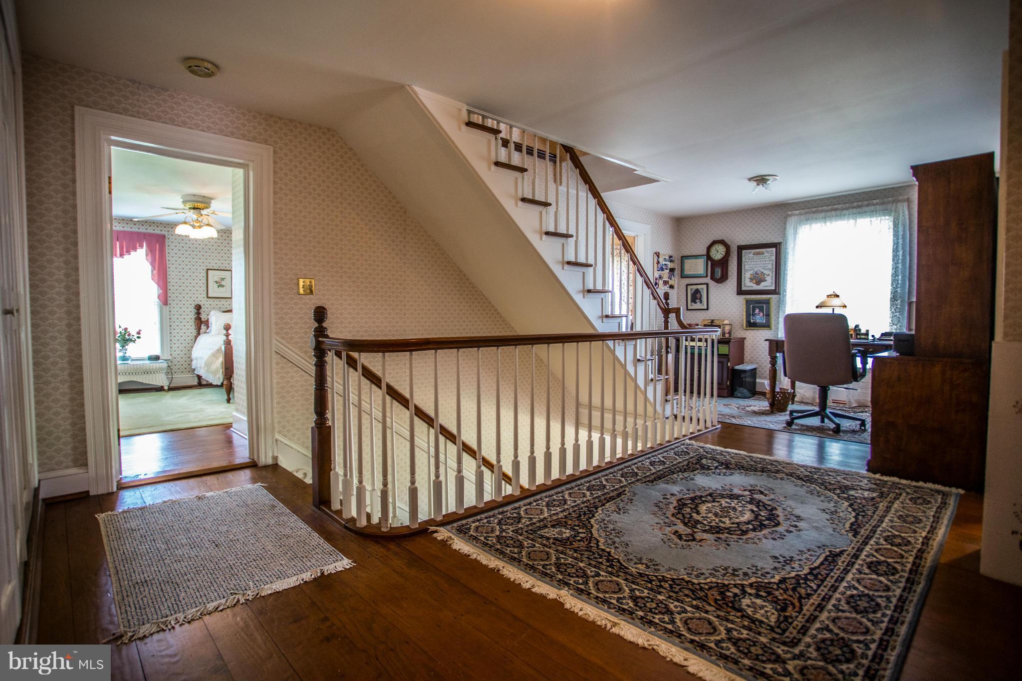 3965 Chaneyville Road Owings, MD 20736 - Photo 14 of 30 a view of a hallway to a livingroom with wooden floor and furniture
