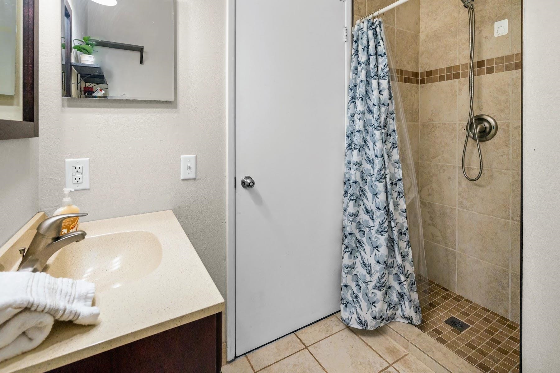 480 Kenolio Road, Unit 12201 Kihei, HI 96753 - Photo 12 of 25 a bathroom with a sink and shower