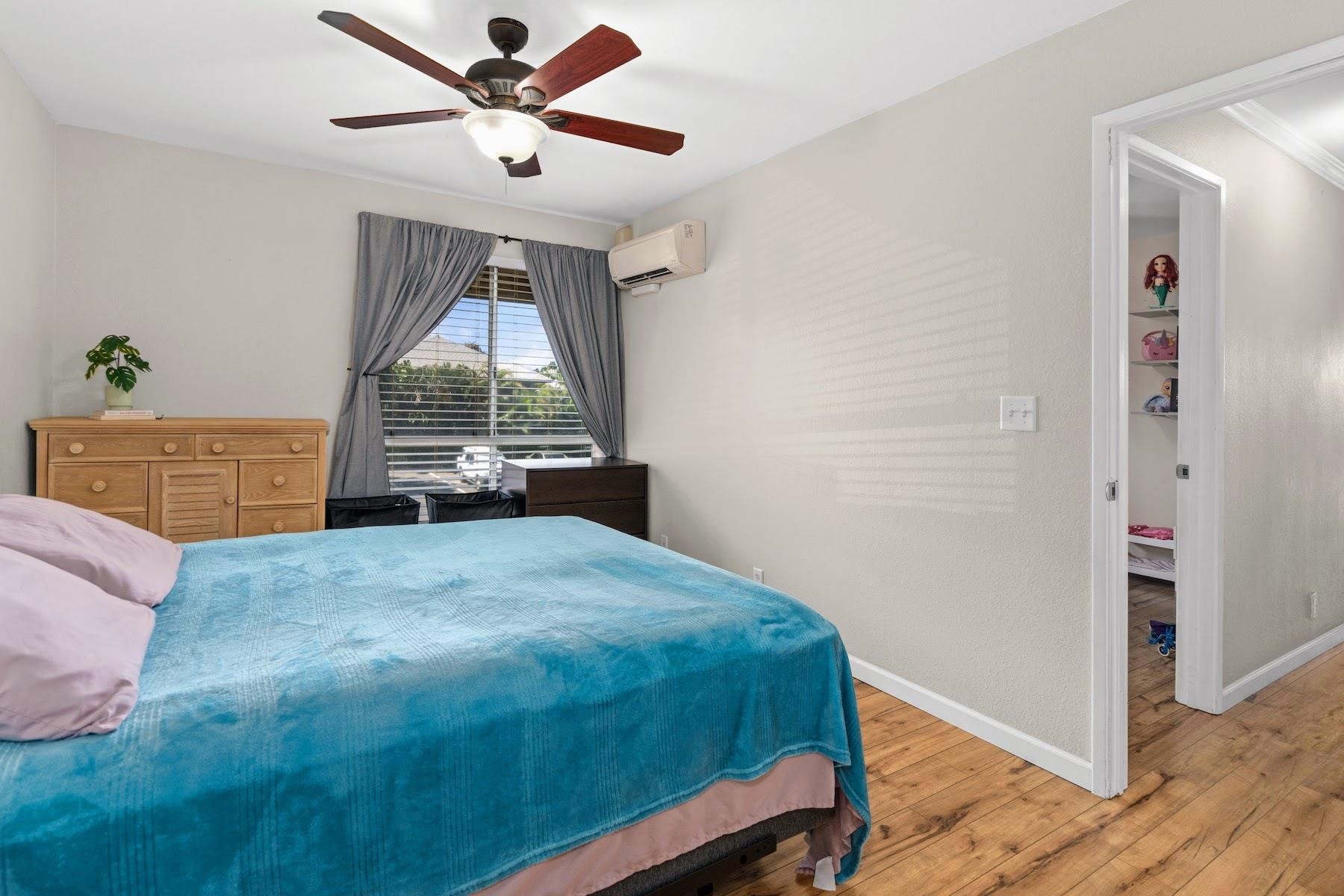 480 Kenolio Road, Unit 12201 Kihei, HI 96753 - Photo 14 of 25 a bed room with a bed and a window