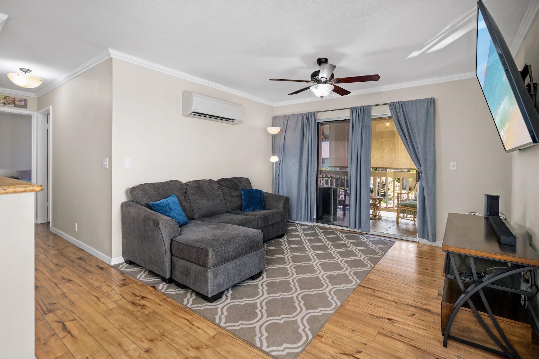 480 Kenolio Road, Unit 12201 Kihei, HI 96753 - Photo 15 of 25 a living room with furniture and a chandelier