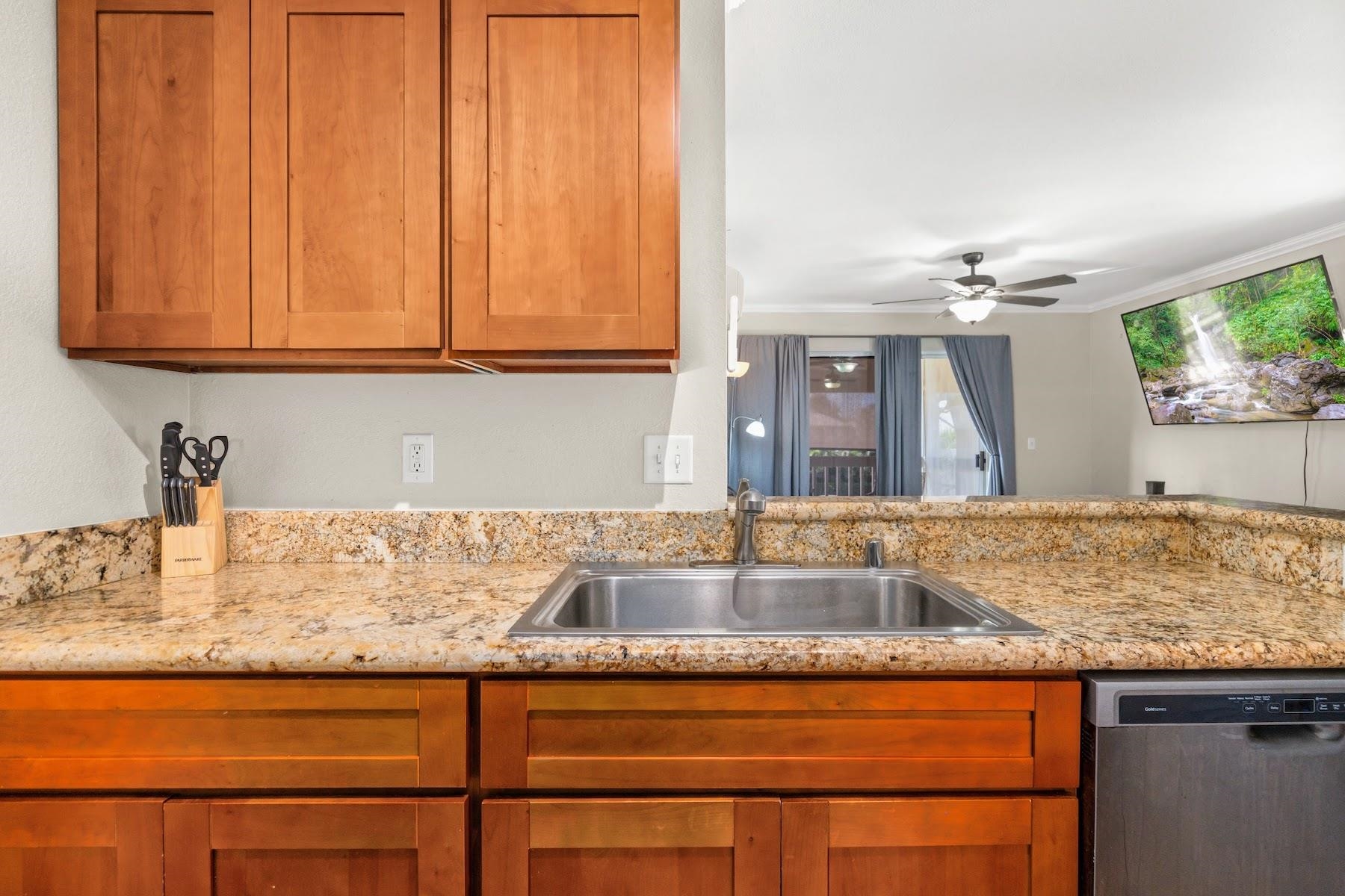 480 Kenolio Road, Unit 12201 Kihei, HI 96753 - Photo 5 of 25 a bathroom with a granite countertop sink and a mirror