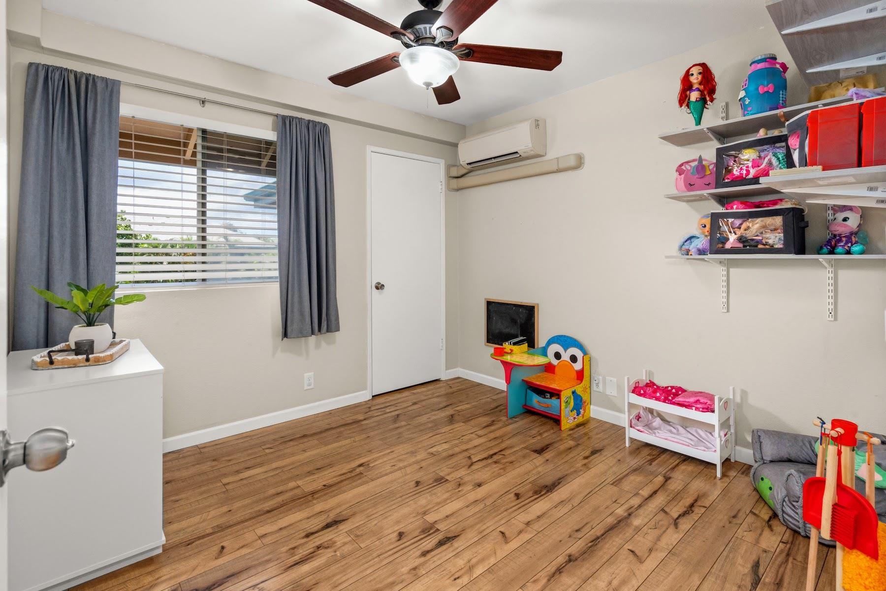 480 Kenolio Road, Unit 12201 Kihei, HI 96753 - Photo 7 of 25 a living room with furniture and a wooden floor