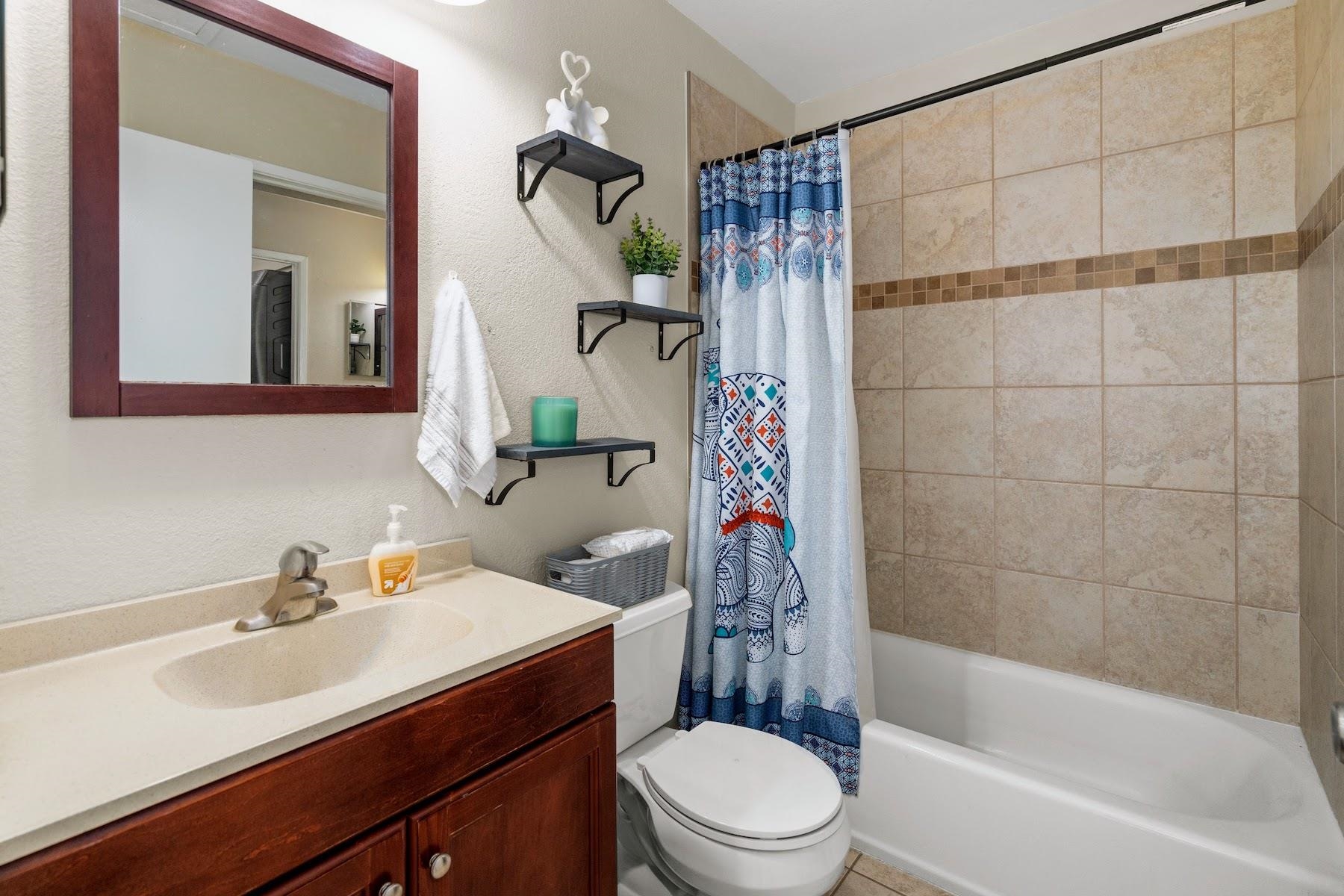 480 Kenolio Road, Unit 12201 Kihei, HI 96753 - Photo 10 of 25 a bathroom with a sink toilet and shower