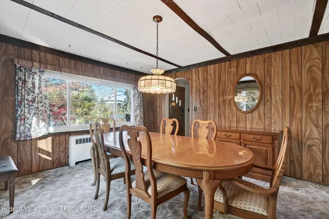 a view of a livingroom with a ceiling fan and window