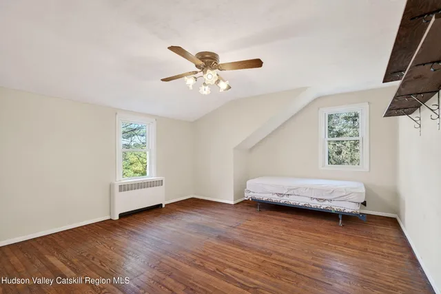 a view of a porch with a bench and some plants