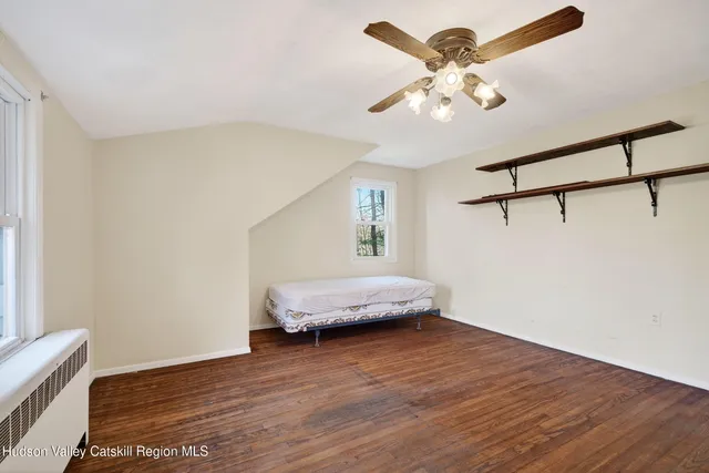 a front view of a house with yard and trees
