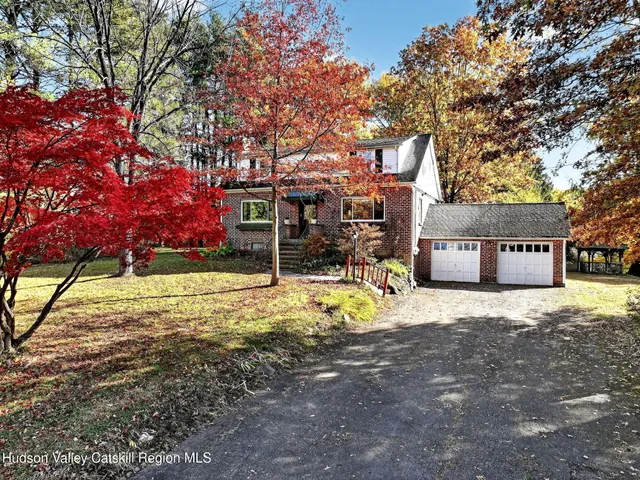 an aerial view of residential houses with outdoor space and lake view